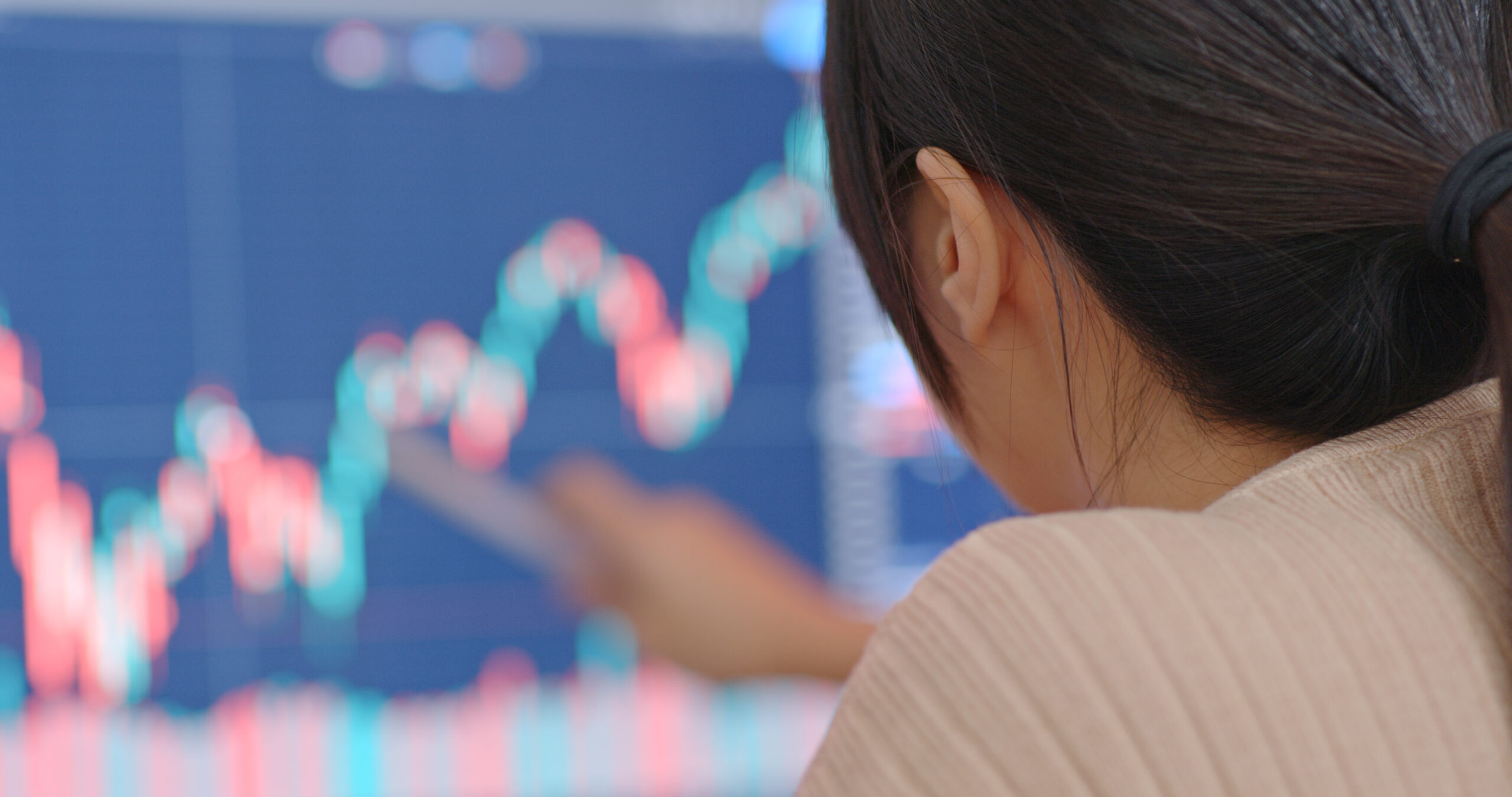 Woman study the stock market data on a computer screen