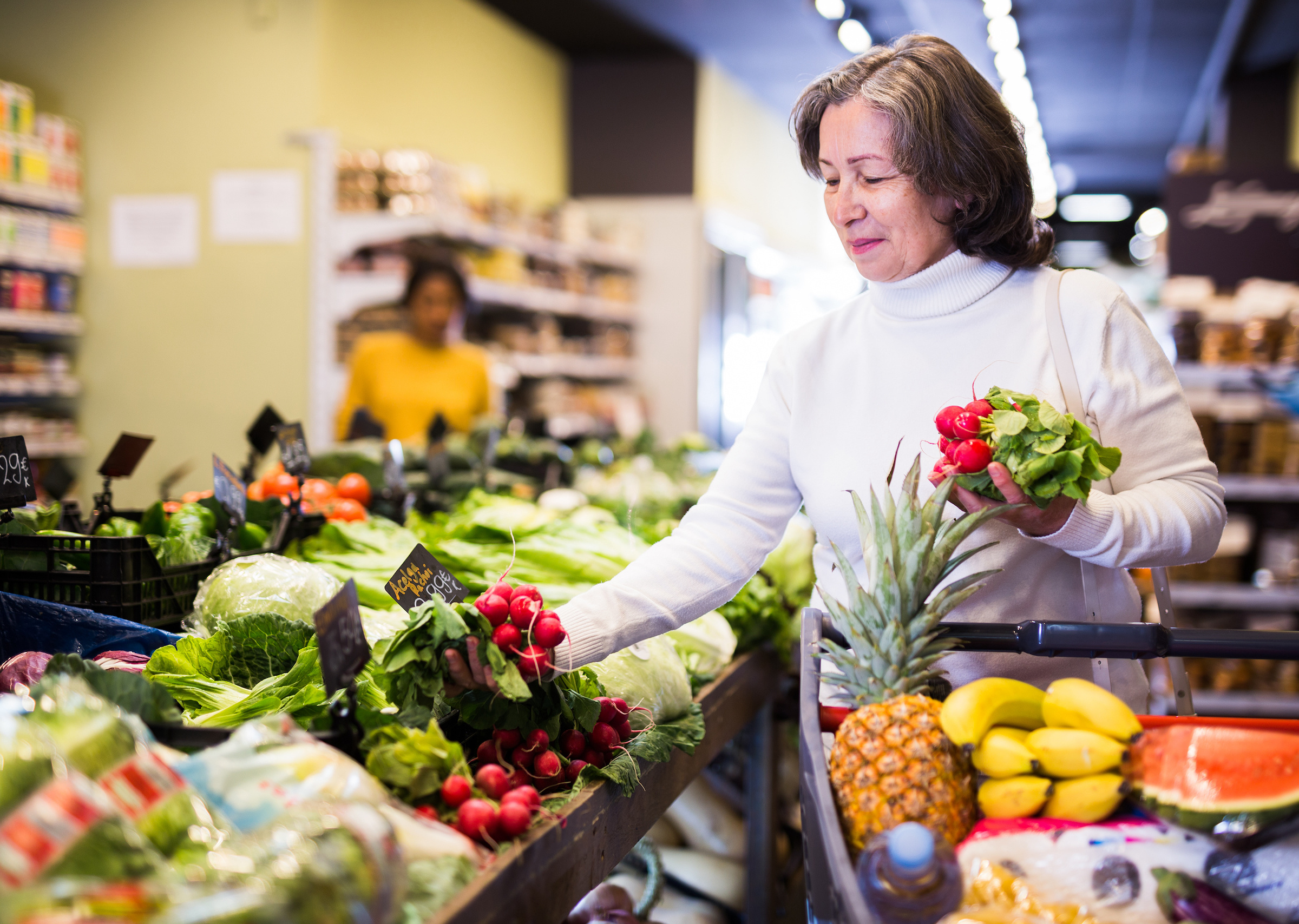 Woman Selecting Vegetables from a Grocery Store