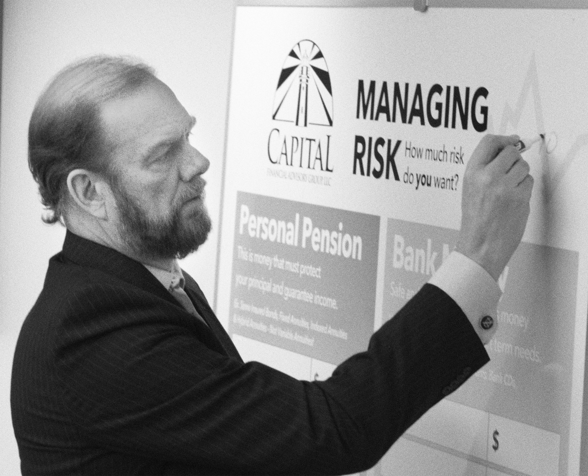 An advisor working at a white board in a conference room